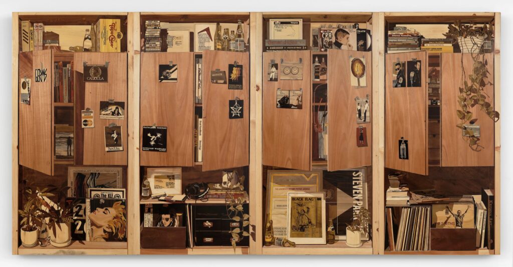 A photo of an intricate four-panel wooden marquetry panel artwork of cabinet and shelves in an artist's studio. 