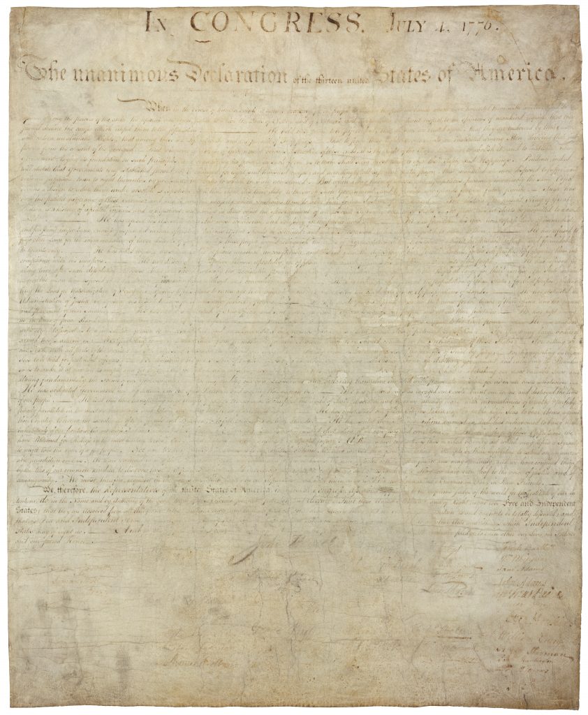 A photo of the signed copy of the Declaration of Independence, which is handwritten and hard to read. 